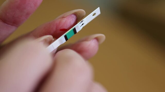 Glucometer. Blood. Finger. Test strip. Slow motion. High quality 4k footage