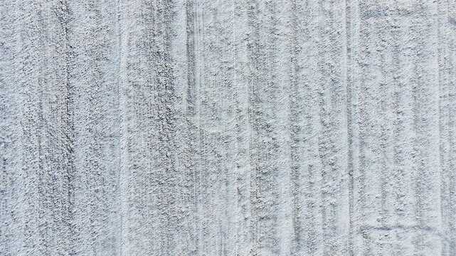 Minimal snowy farm field from aerial perspective