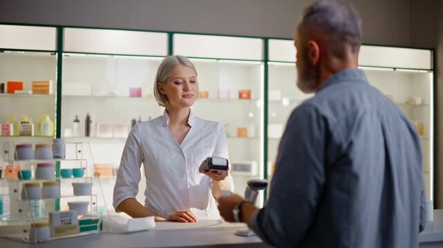 Pharmacist typing terminal machine providing payment packing pills in cashier