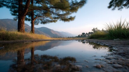 Obraz premium Serene twilight scene capturing reflections of mountains and trees in still waters