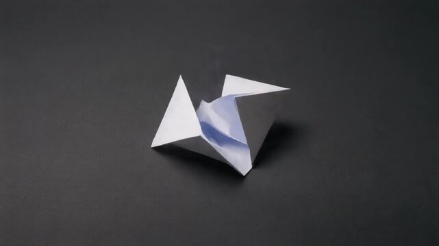 White paper sheet folding into a geometric shape in a seamless looping motion captured in high quality 4k resolution for professional creative design and artistic projects