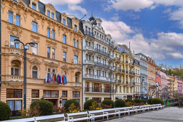 Naklejka premium Historic building facades in Karlovy Vary, Czech Republic. Colorful neorenaissance architecture under cloudy sky