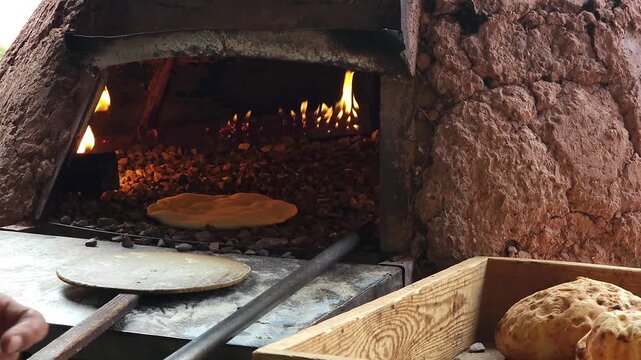 Close-up of dough pieces for traditional Moroccan tafarnout bread, baked in a traditional oven on small stones in a local bakery. The concept of traditional Moroccan cuisine, homemade baking