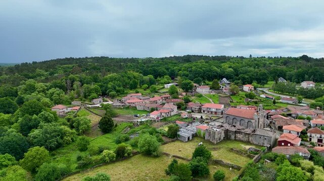 Aerial orbiting view of the historic Santa Marina de Augas Santas church in Galicia, Spain