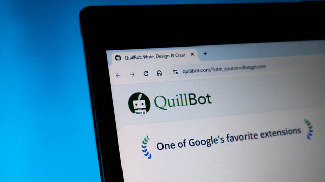 Closeup of a laptop screen displaying the quillbot website, a popular aipowered writing and paraphrasing tool, against a blue background