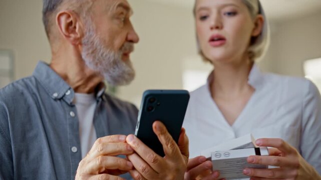 Man hands holding smartphone indoors closeup. Lady assistant advising tablets
