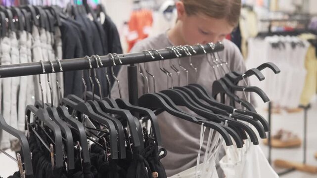 Concept girl schoolgirl shopping in a shopping mall,