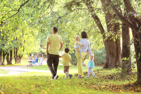 Family with children for a walk in the summer park. Сoming autumn&nbsp;in the park. Family. Fall. Happiness.