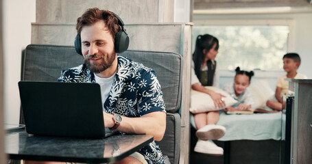 Freelancer, headphones and man in camper van on laptop for travel blog, copywriting or remote work....