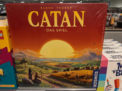 Catan Board Game Box Art Featuring a Sunset