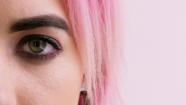 Face, optometry and eye of woman in studio for eyesight, vision test and optical exam for glasses. Optician, half and portrait of person for health, eyecare and prescription lens on pink background
