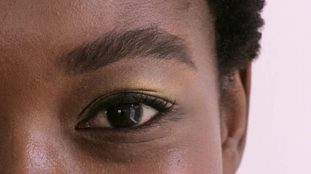Eye, optometry and face of black woman in studio with eyesight, vision or optical health. Ophthalmology, closeup and portrait of female person with eyecare, retina or wellness by white background.