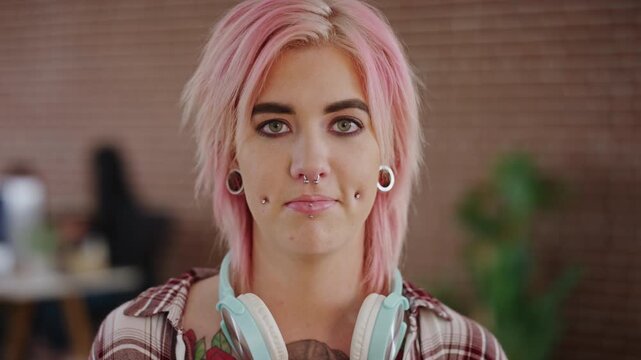 Girl, face or stylist with headphones for creative career, internship or fashion program. Portrait, female person or aesthetic designer with pink hair, piercings or jewelry for editorial styling