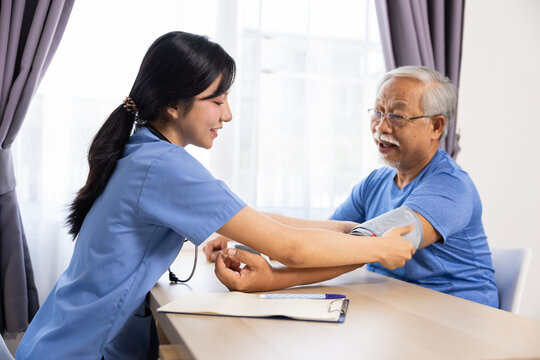 Blood pressure nurse senior man healthcare home care medical checkup patient caregiver sphygmomanometer stethoscope, nurse measure blood pressure for senior man during healthcare home care medical