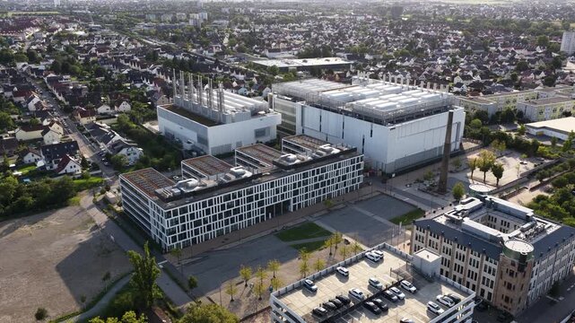 Aerial view orbiting modern industrial complex and data center