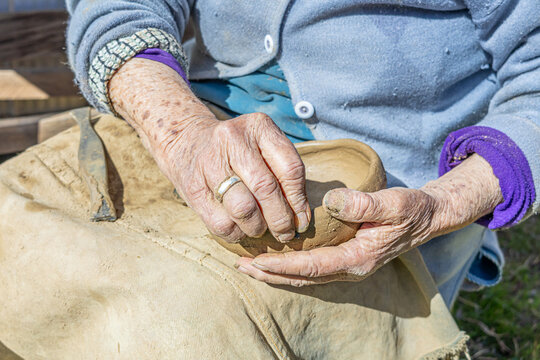  Cauquenes, Chile - March 26, 2026: A 90-year-old artisan works, shaping clay with her hands to create traditional pieces such as bowls, cups, and jugs, keeping a cultural tradition alive.