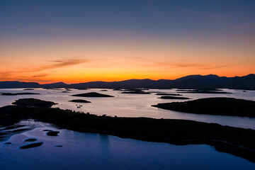 Obraz premium Aerial sunset view over Clew Bay near Westport, County Mayo, Ireland. Scenic Atlantic bay with drumlin islands and mountain silhouettes on the Wild Atlantic Way.