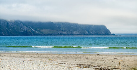 Obraz premium Keel Beach on Achill Island, County Mayo, Ireland. Misty cliffs, gentle waves and Atlantic shoreline on the Wild Atlantic Way.