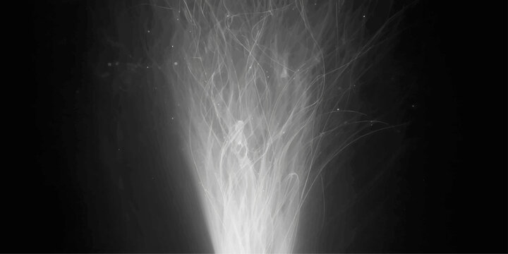A dark motion of water falls through night mist and blue fog under a stormy sky as a spotlight illuminates the steam and cloud texture against a black nature backdrop