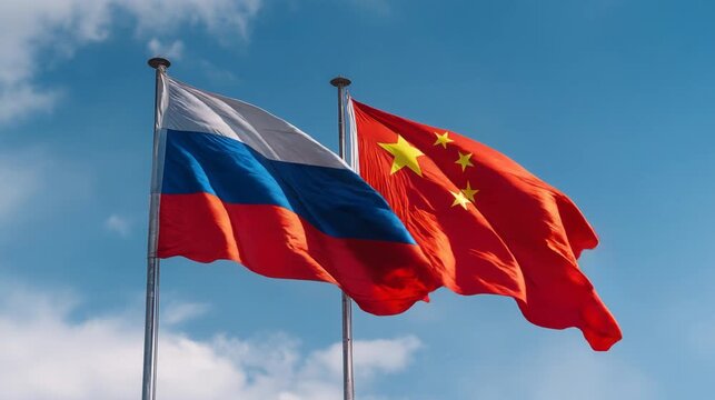 russian flag waving with chinese flag in blue sky. relations between russia and china
