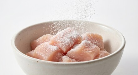 Fototapeta premium Probiotic powder landing on fresh raw chicken cubes