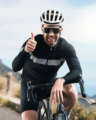 Naklejka premium Man, bike and thumbs up outdoor for training, fitness or achievement on mountain road. Athlete person, smile and sunglasses for workout, exercise and cyclist with hand gesture for win in nature