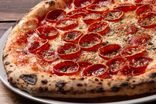 Close up of pepperoni pizza with melted cheese and crispy crust, detailed italian pizza texture photography
