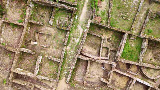 Aerial revealing view of Castro de Armea ancient ruins disappearing into forest