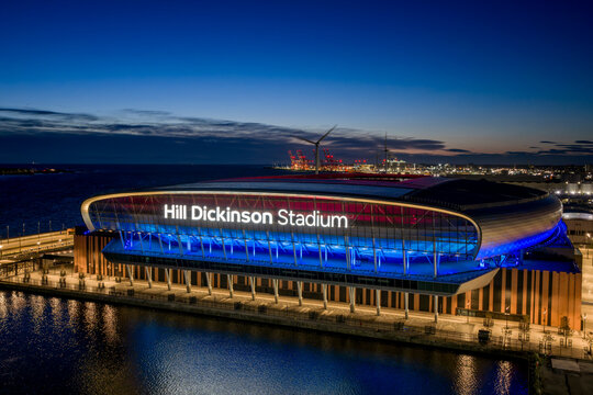 Everton Football Club, Hill Dickinson Stadium illuminated at night on Liverpool waterfront with modern architecture and Everton football venue.