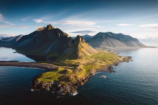 Aerial View of Eystrahorn mountain by coastal peninsula during golden hour in East Iceland