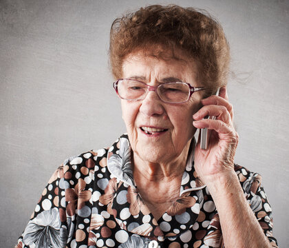 Seniors talking mobile phone, studio shot. Old happy adult mature woman