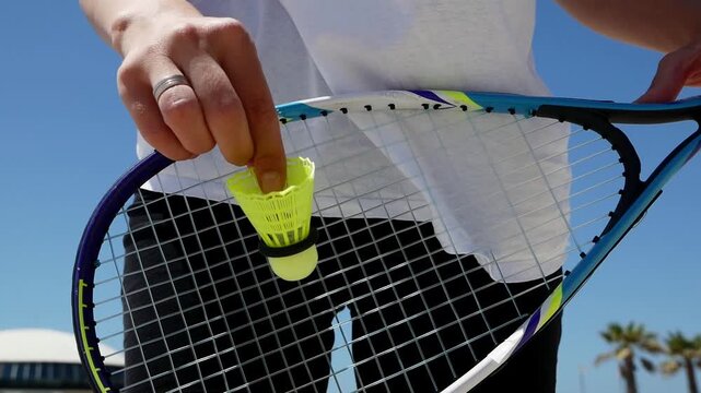 Speed badminton racket shuttlecock close up, outdoor summer sport, crossminton game, active lifestyle, fitness recreation blue sky.