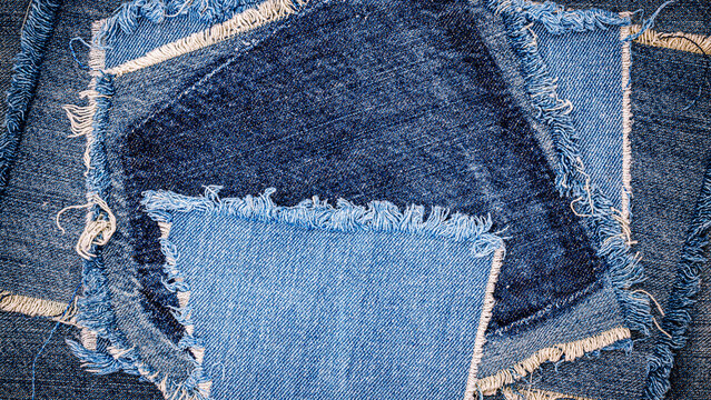 Different pieces of denim fabric arranged in a circular pattern in a textile workspace
