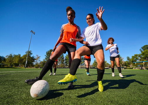 Diverse Group of Women Playing Soccer Together Outdoors