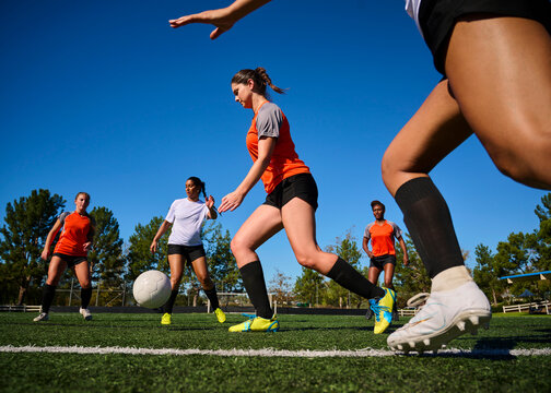 Diverse Group of Women Playing Soccer Together Outdoors