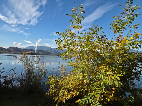 Industrial power plant by the lake surrounded by autumn nature, Velenje, Slovenia, 50MP