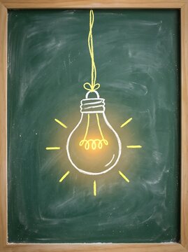 Chalk drawn glowing light bulb on a green chalkboard hanging by a string