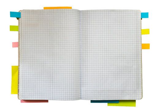 Open blank graph paper notebook with colorful sticky tabs around the pages, suitable for planning, study, organization, and stationery design concepts.