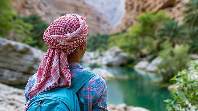 Rear view of a person at Wadi Shab canyon near Tiwi in Oman, Arabian Peninsula hiking concept, Oman canyon photography, Middle East canyon adventure, defocused background, with