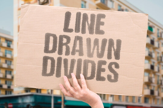 "Line Drawn Divides" A line drawn by past rulers permanently divides communities sharing common roots. DRAWN. RULERS. DIVIDES. COMMUNITIES. ROOTS.