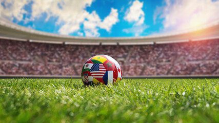 Fototapeta premium a soccer ball with various national flags on the soccer stadium. International soccer competition concept.