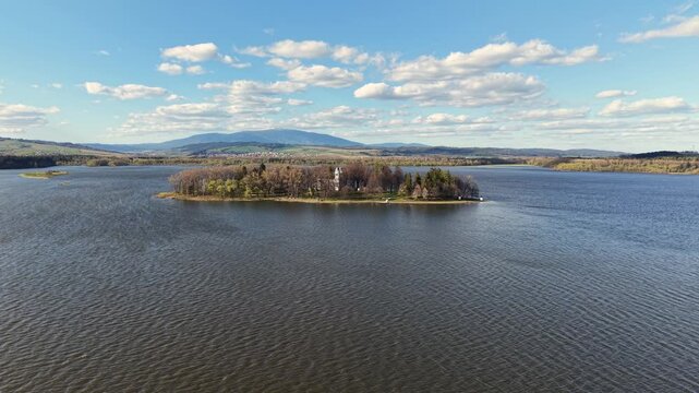 Stunning aerial perspective of Slanica Art Island with its historic Church of the Exaltation of the Holy Cross on Orava Reservoir, Slovakia