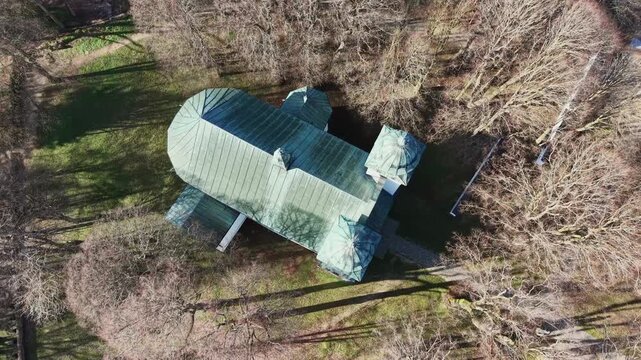 Stunning top down aerial footage orbiting the historic Church of the Exaltation of the Holy Cross on Slanica Art Island in Slovakia