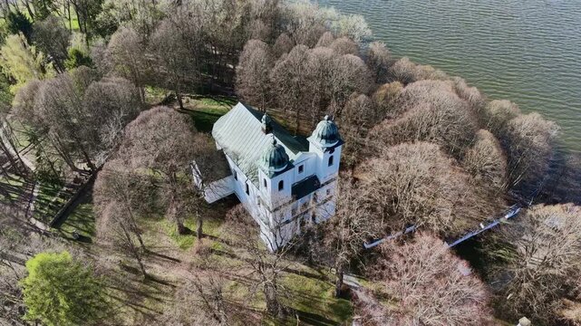 Stunning aerial footage showing the historic Church of the Exaltation of the Holy Cross on Slanica Art Island in the Orava reservoir