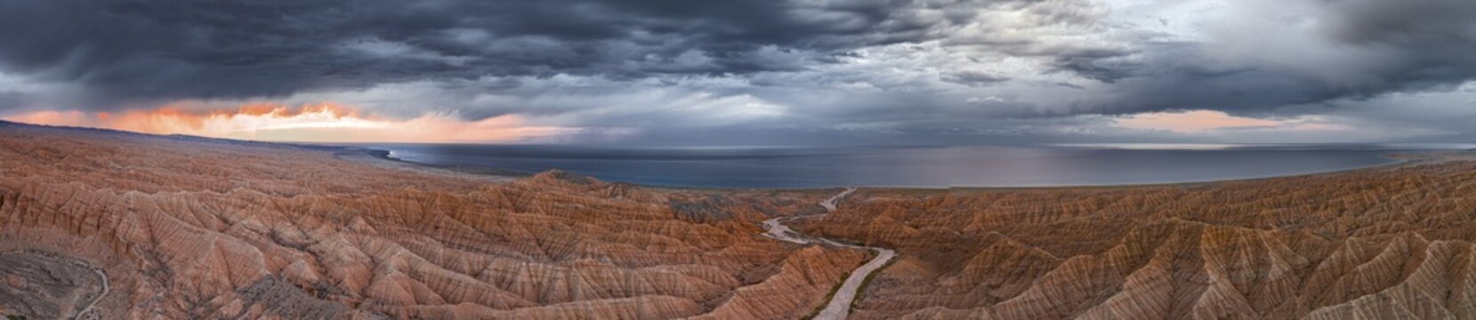 Evening mood, Canyon runs through landscape, Issyk Kul Lake, Dramatic barren landscape of eroded hills, Badlands, Canyon of the Forgotten Rivers, Issyk Kul, Kyrgyzstan