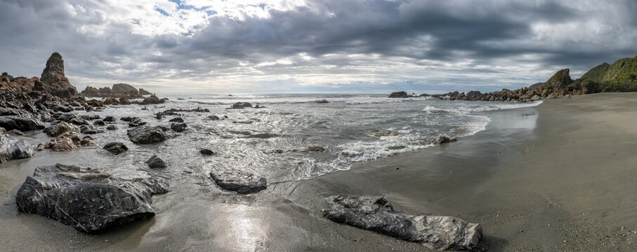 Rocks on the beach, rain clouds, West Coast, South Island, New Zealand