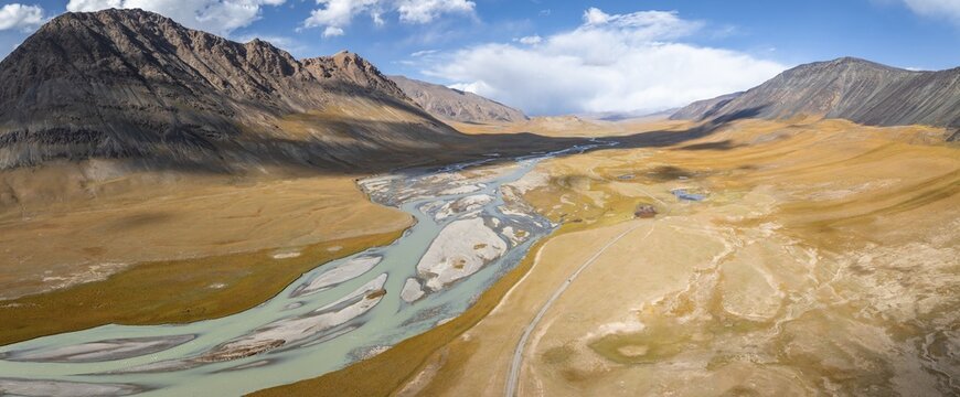 Aerial view, Burkhan mountain valley with meandering river, barren dramatic mountain landscape, Terskey Ala-Too, Tien Shan, Issyk Kul province, Kyrgyzstan
