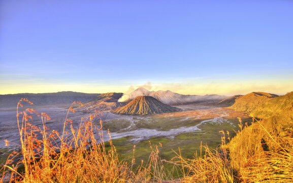 Sunrise, smoking volcano Mount Bromo, Mt. Batok at front, Mt. Kursi at back, Mt. Gunung Semeru, Bromo Tengger Semeru National Park, Java, Indonesia
