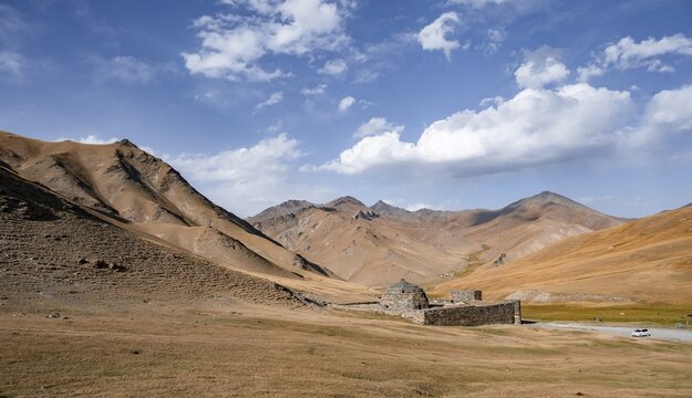 Historic caravanserai Tash Rabat from the 15th century, with yellow hills, Atbashy district in the Naryn region, Kyrgyzstan