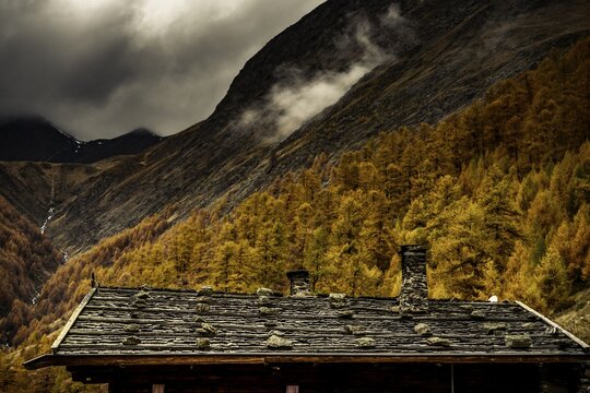 Alpine hut in autumnal mountain landscape with threatening cloudy sky, Pfossental, Merano, Vinschgau, South Tyrol, Italy